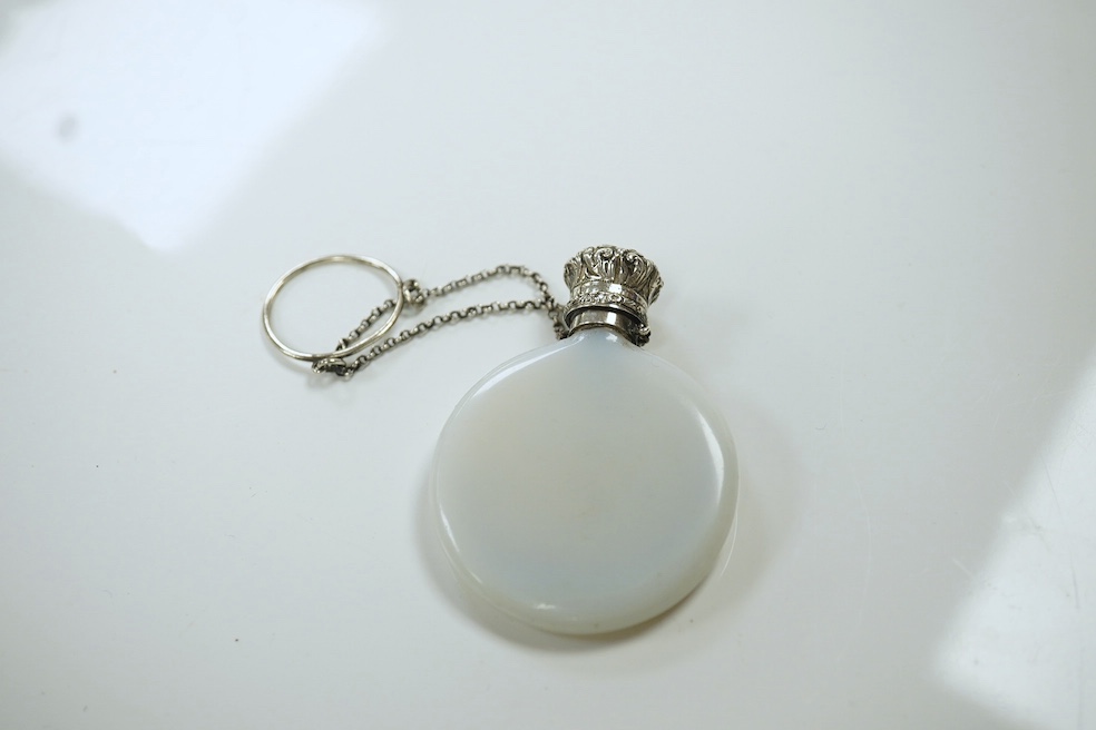 A late Victorian white metal mounted opaline glass R & B Cooper patent moon shaped scent bottle, 57mm, with suspension chain. Condition - fair